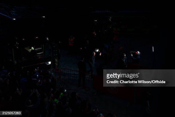 Manchester United manager Erik ten Hag is caught in a shaft of light as he arrives at the stadium ahead of the Premier League match between Brentford...