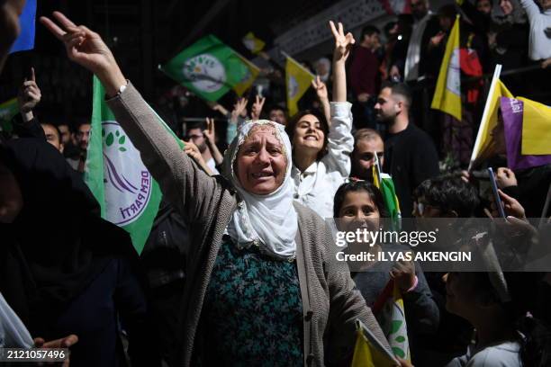 Supporters of pro-Kurdish Peoples' Equality and Democracy Party celebrate following the early results of the local elections in Diyarbakir, Turkey,...