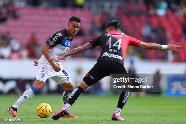 Pablo Barrera of Queretaro dribbles against Luis Reyes of Atlas during the 13th round match between Atlas and Queretaro as part of the Torneo...