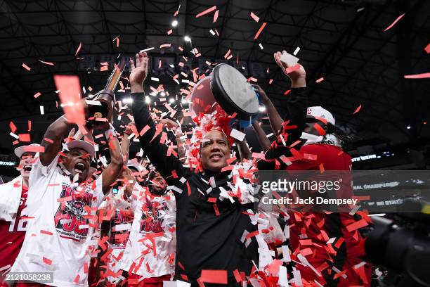 Head coach Kevin Keatts of the North Carolina State Wolfpack and team celebrate after defeating the Duke Blue Devils during the Elite Eight round of...