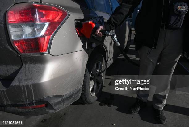 Person fills up a fuel tank at a pay-at-the-pump gasoline station in Edmonton, on March 31 in Edmonton, Alberta, Canada. Tomorrow, fuel prices will...