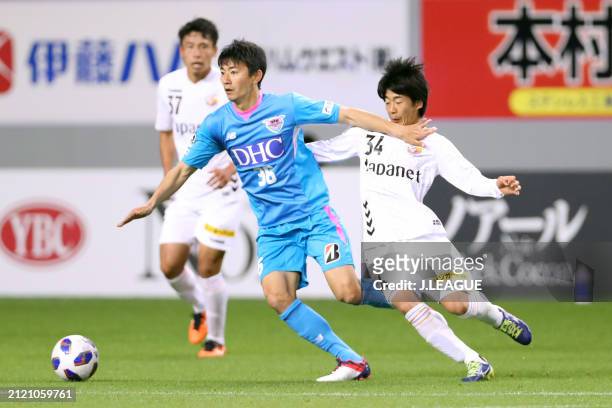 Hideto Takahashi of Sagan Tosu controls the ball against Takumi Nagura of V-Varen Nagasaki during the J.League YBC Levain Cup Group D match between...