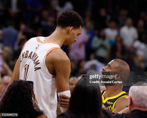 Victor Wembanyama of the San Antonio Spurs is greeted by Chris Paul of the Golden State Warriors at the end of the game at Frost Bank Center on March...