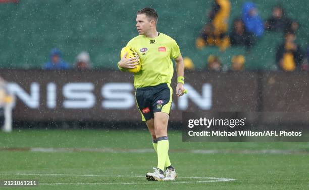 Umpire Nick Foot calls a pause in play due to nearby lightning strikes during the 2024 AFL Round 03 match between the Hawthorn Hawks and the Geelong...