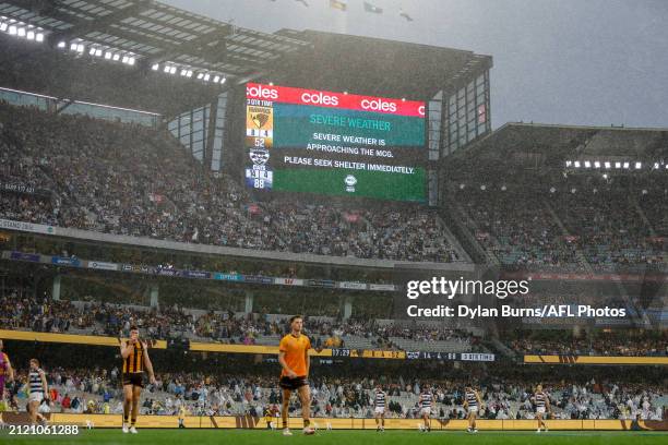 Play stops due to severe weather during the 2024 AFL Round 03 match between the Hawthorn Hawks and the Geelong Cats at the Melbourne Cricket Ground...