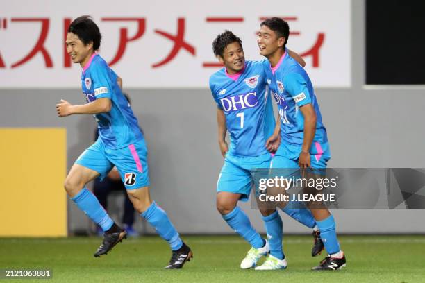 Kaisei Ishii of Sagan Tosu celebrates with teammates Hiroki Kawano and Kohei Kato after scoring the team's first goal during the J.League YBC Levain...