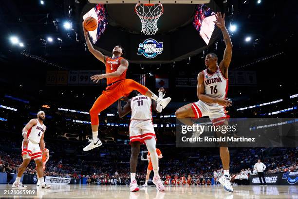 Chase Hunter of the Clemson Tigers lays up against Keshad Johnson of the Arizona Wildcats during the first half in the Sweet 16 round of the NCAA...