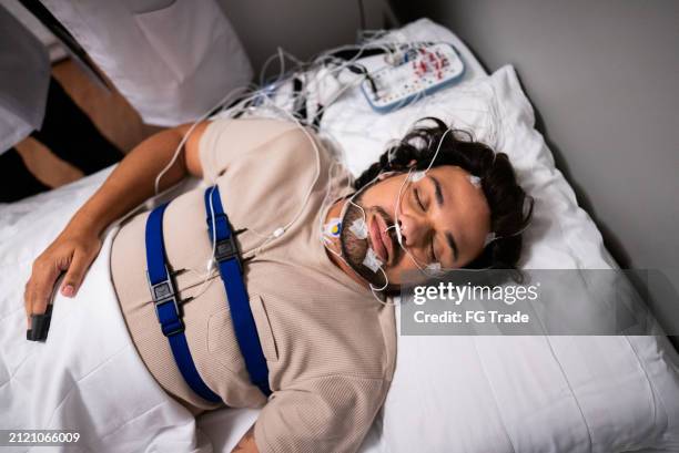 patient sleeping in a medical clinic doing polysomnography - eeg stock pictures, royalty-free photos & images