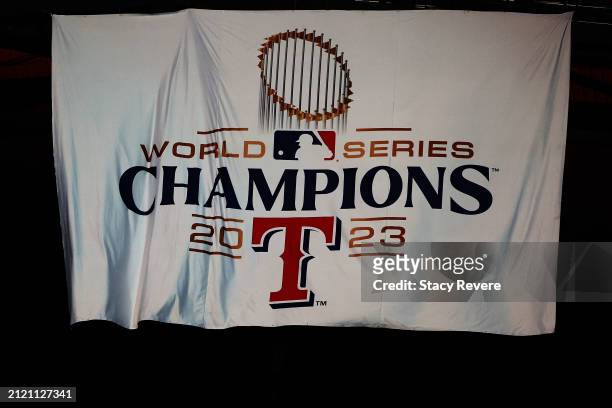 The Texas Rangers unveil their 2023 World Series Champions banner prior to the Opening Day game against the Chicago Cubs at Globe Life Field on March...