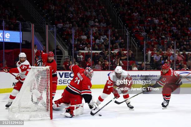 Frederik Andersen of the Carolina Hurricanes makes a save against David Perron of the Detroit Red Wings during the first period of the game at PNC...