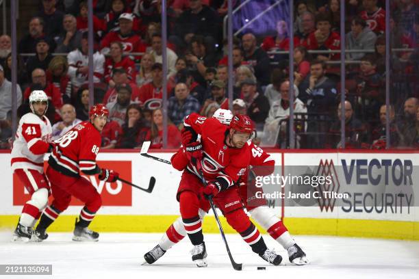 Evgeny Kuznetsov of the Carolina Hurricanes and Jeff Petry of the Detroit Red Wings work for possession during the first period of the game at PNC...