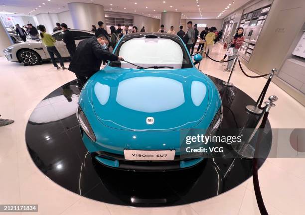 Xiaomi's new energy vehicle SU7 is displayed at Xiaomi Electric Vehicle Flagship Store on March 28, 2024 in Beijing, China. The Xiaomi SU7 was...