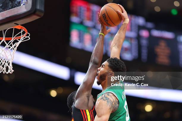 Clint Capela of the Atlanta Hawks blocks a dunk attempt by Jayson Tatum of the Boston Celtics during the second quarter at State Farm Arena on March...