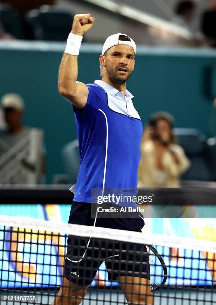 Grigor Dimitrov of Bulgaria celebrates after defeating Carlos Alcaraz of Spain during their match on Day 13 of the Miami Open at Hard Rock Stadium on...