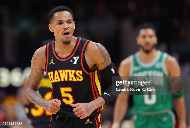 Dejounte Murray of the Atlanta Hawks reacts after hitting a three-point basket against the Boston Celtics during the first quarter at State Farm...