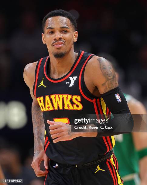 Dejounte Murray of the Atlanta Hawks reacts after hitting a three-point basket against the Boston Celtics during the first quarter at State Farm...