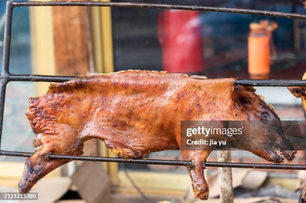 roasted sucking pig or roasted baby pig on the iron frame. - brazier stock pictures, royalty-free photos & images