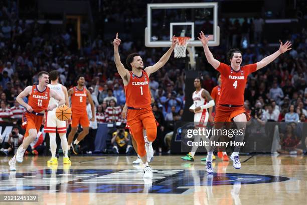 Chase Hunter, Ian Schieffelin and Joseph Girard III of the Clemson Tigers celebrates after defeating the Arizona Wildcats during the second half in...