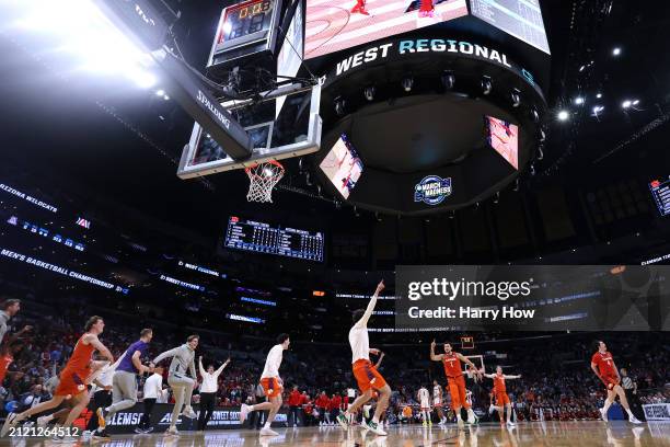 The Clemson Tigers celebrate after defeating the Arizona Wildcats during the second half in the Sweet 16 round of the NCAA Men's Basketball...