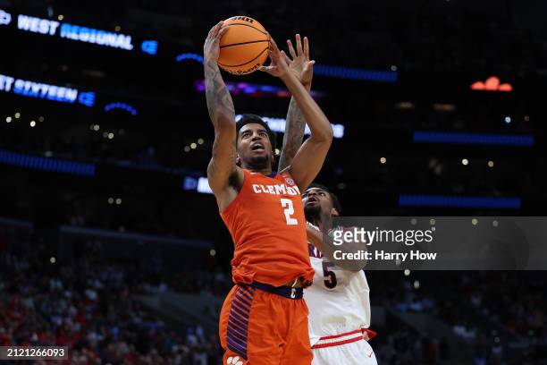 Dillon Hunter of the Clemson Tigers is fouled by KJ Lewis of the Arizona Wildcats during the second half in the Sweet 16 round of the NCAA Men's...