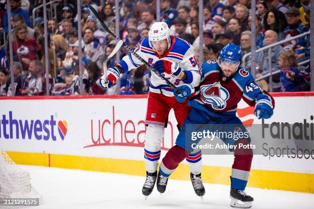 Will Cuylle of the New York Rangers attempts to push past Samuel Girard of the Colorado Avalanche during the first period of the game at Ball Arena...