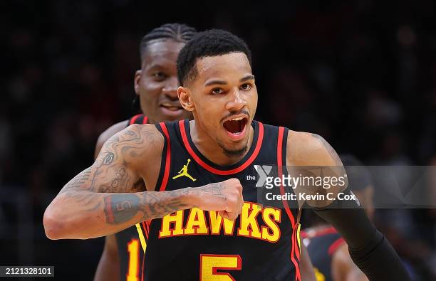 Dejounte Murray of the Atlanta Hawks reacts after hitting the game-winning basket during overtime against the Boston Celtics at State Farm Arena on...