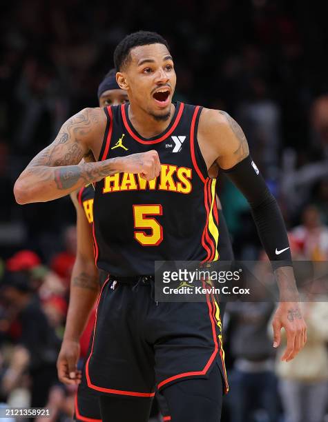 Dejounte Murray of the Atlanta Hawks reacts after hitting the game-winning basket during overtime against Jrue Holiday of the Boston Celtics at State...