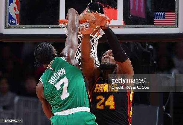 Jaylen Brown of the Boston Celtics dunks over Bruno Fernando of the Atlanta Hawks during third quarter at State Farm Arena on March 28, 2024 in...