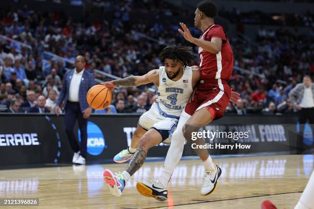 Davis of the North Carolina Tar Heels is fouled by Rylan Griffen of the Alabama Crimson Tide as he drives during the second half in the Sweet 16...