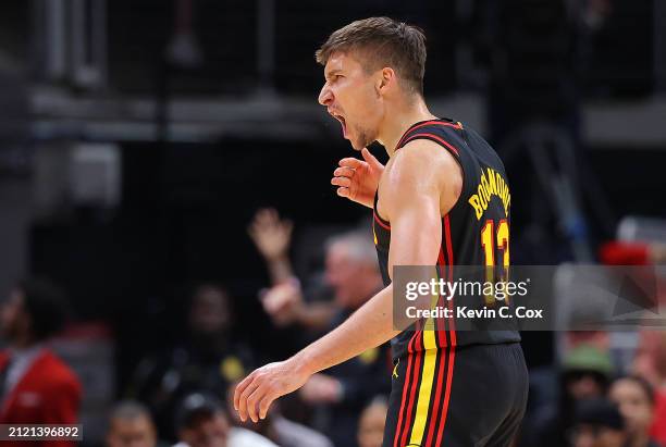 Bogdan Bogdanovic of the Atlanta Hawks reacts after shooting a three-point basket against the Boston Celtics during the fourth quarter at State Farm...