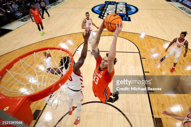 Coleman Hawkins of the Illinois Fighting Illini dunks the ball against Tre King of the Iowa State Cyclones during the first half in the Sweet 16...