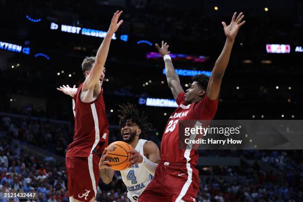 Davis of the North Carolina Tar Heels is fouled by Nick Pringle of the Alabama Crimson Tide during the second half in the Sweet 16 round of the NCAA...