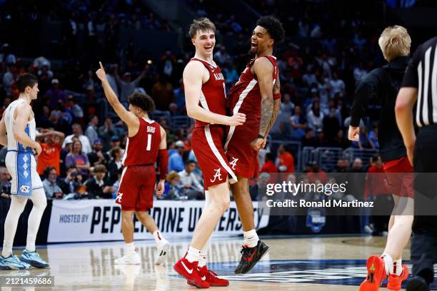 Grant Nelson, Aaron Estrada and Mark Sears the Alabama Crimson Tide celebrate after defeating the North Carolina Tar Heels during the second half in...