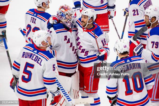 Igor Shesterkin and Vincent Trocheck of the New York Rangers hug amidst their teammates afetr the team defeated the Colorado Avalanche 3- at Ball...