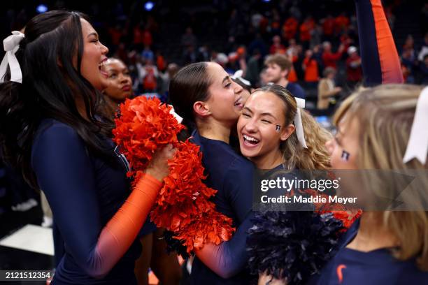 Members of the Illinois Fighting Illini cheerleaders celebrate after defeating the Iowa State Cyclones in the Sweet 16 round of the NCAA Men's...