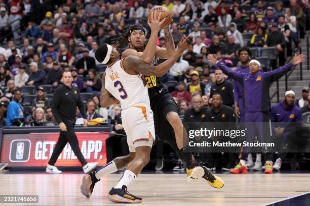 Aaron Gordon of the Denver Nuggets drives against Bradley Beal of the Phoenix Suns during the third quarter at Ball Arena on March 27, 2024 in...