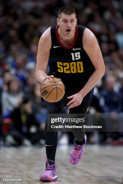 Nikola Jokic of the Denver Nuggets brings the ball down the court against the Phoenix Suns during the third quarter at Ball Arena on March 27, 2024...