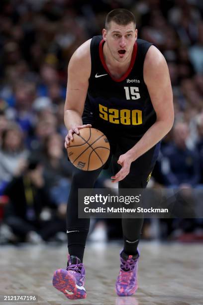 Nikola Jokic of the Denver Nuggets brings the ball down the court against the Phoenix Suns during the third quarter at Ball Arena on March 27, 2024...