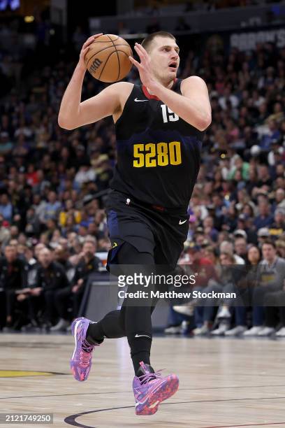 Nikola Jokic of the Denver Nuggets drives against he Phoenix Suns during the third quarter at Ball Arena on March 27, 2024 in Denver, Colorado. NOTE...
