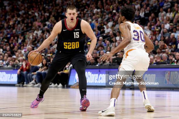 Nikola Jokic of the Denver Nuggets is guarded by Thaddeus Young of the Phoenix Suns during the fourth quarter at Ball Arena on March 27, 2024 in...