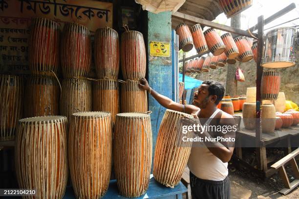 An artisan is arranging a traditional dhol ahead of the Rongali Bihu festival in Nagaon District, Assam, India, on April 1, 2024. The dhol is widely...