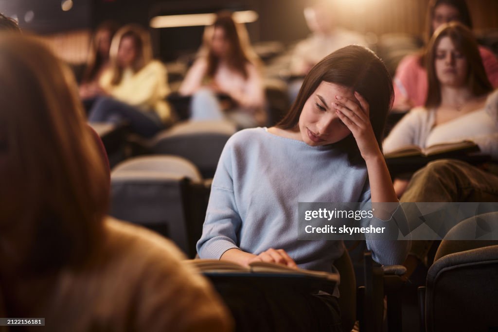 Confusing Lecture Worried College Student Reading A Lecture On A Class In Amphitheater ...