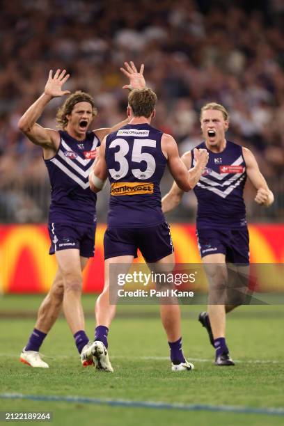 Josh Treacy of the Dockers celebrates a goal with Nat Fyfe and Hayden Young during the round three AFL match between Fremantle Dockers and Adelaide...