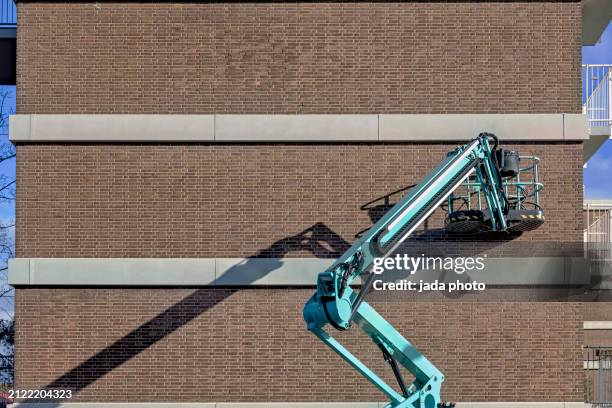 blue steel aerial platform stands outside - hydraulisch platform stockfoto's en -beelden