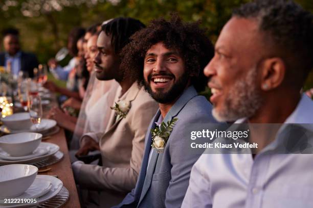 portrait of happy best man sitting at dining table - trauzeuge des bräutigams stock-fotos und bilder