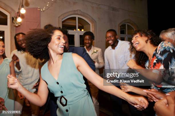 happy woman dancing amidst guests during reception - guest stock pictures, royalty-free photos & images