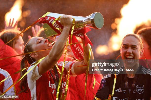 Katie McCabe of Arsenal Women celebrates winning the Continental Tyres League Cup by drinking champagne from the trophy during the FA Women's...