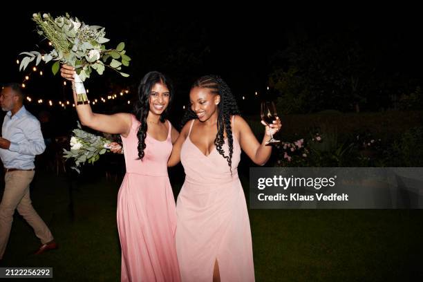 cheerful multiracial bridesmaids dancing at reception - invitato a un matrimonio foto e immagini stock