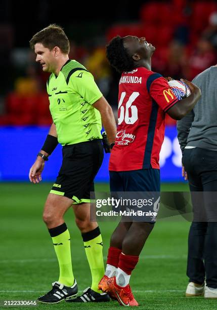 Nestory Irankunda of Adelaide United receives the match ball from referee Adam Kersey after after then final whistle for his hatrick during the...