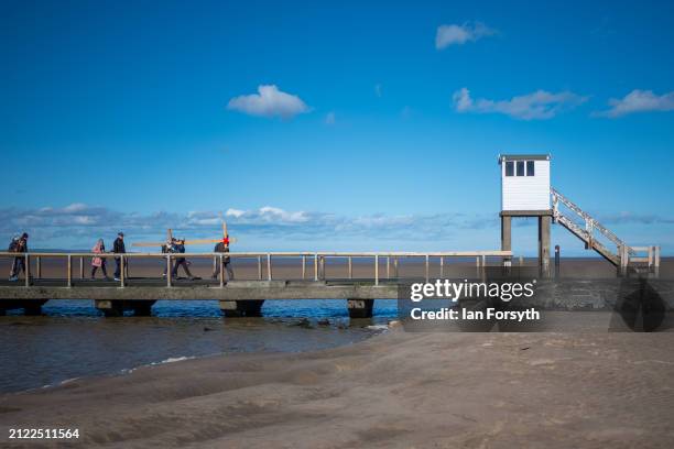 Pilgrims celebrate Easter by carrying wooden crosses as they walk over the tidal causeway to Lindisfarne during the final leg of their annual Good...